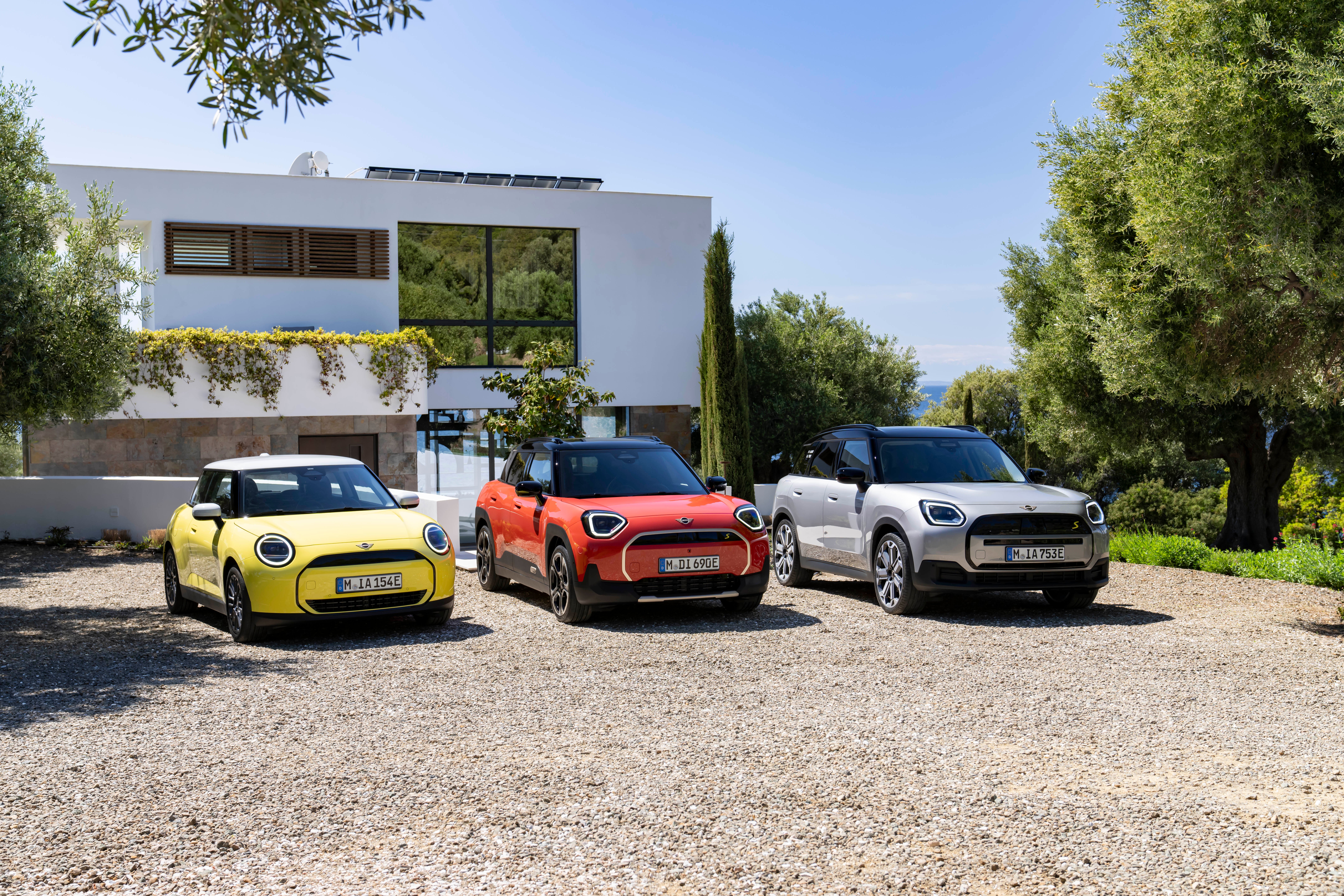 The new Mini family includes the yellow Cooper, orange Aceman and silver Countryman